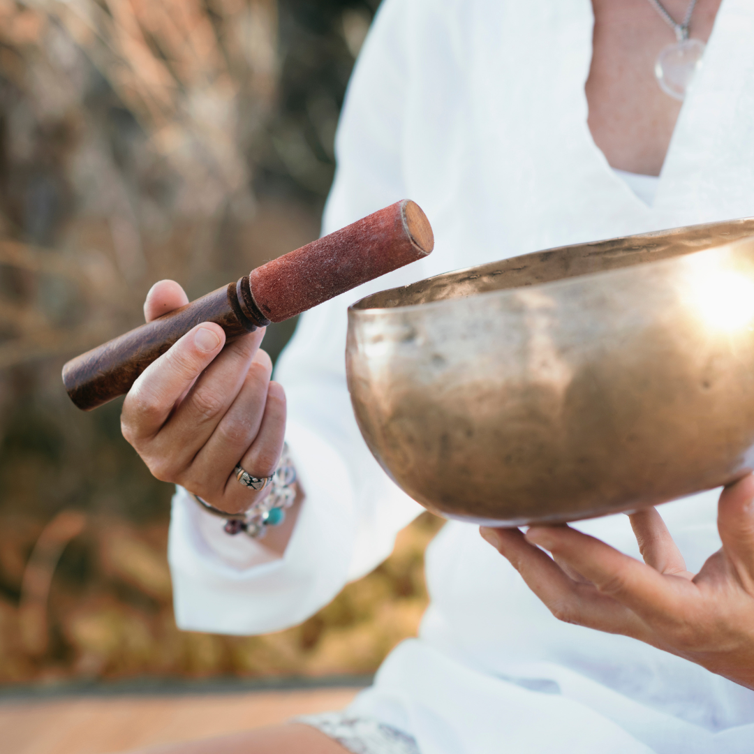 person holding a sound bath